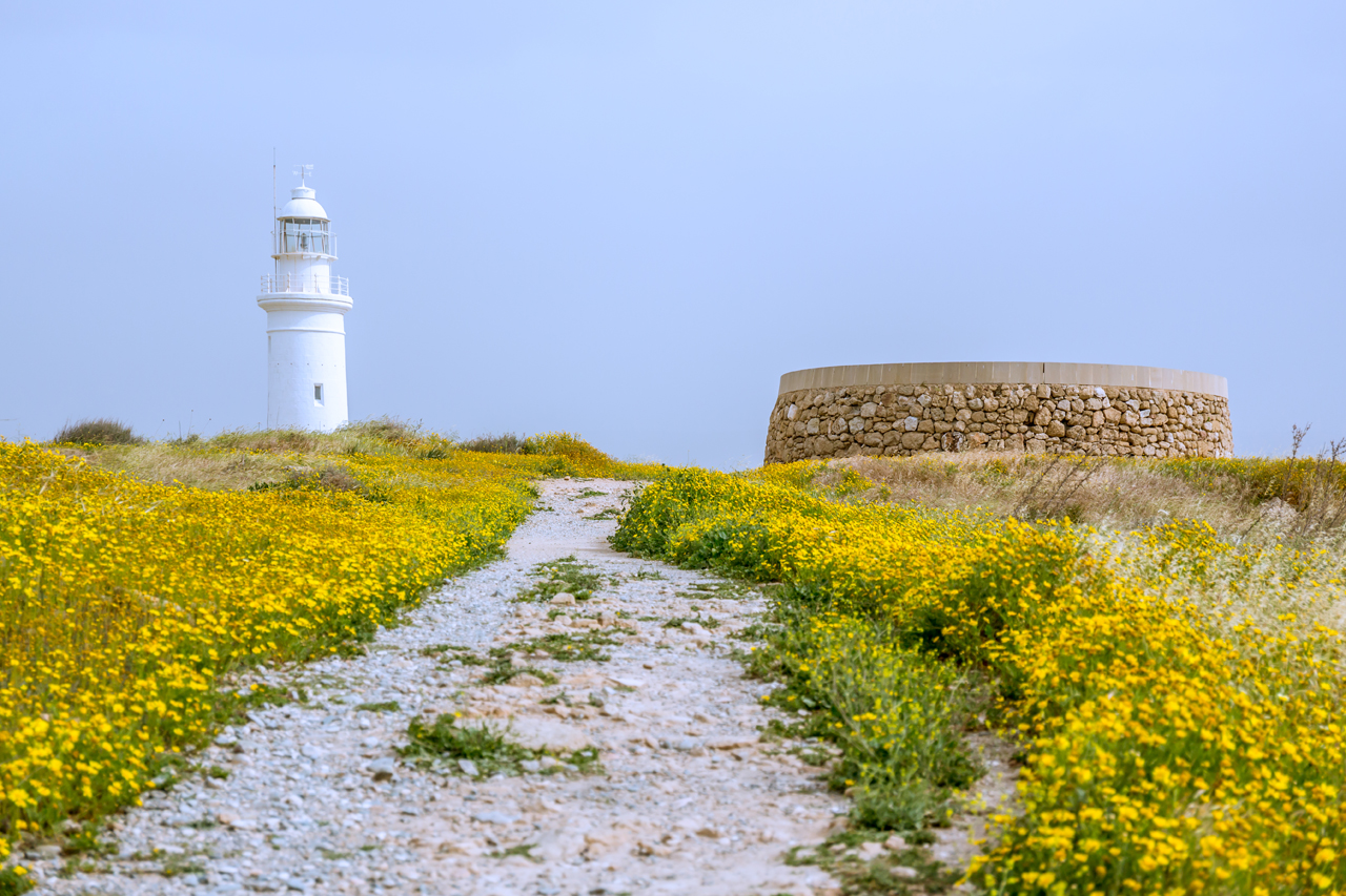 A pristine white lighthouse provides a stunning backdrop to Nea Pafos (New Paphos) excavation site - Seeing more heritage gems from Cyprus, it increasingly became clear that over the centuries, Cypriots have demonstrated amazing talent. They not only showcased talent in their three-millennia old mosaics but also via the painted churches from the medieval Byzantine era - Cyprus - Beyond the Mediterranean Hues. #WorldHeritageSite #UNESCOWorldHeritageList #CyprusUNESCOSites #Mosaics #ByzantineChurches