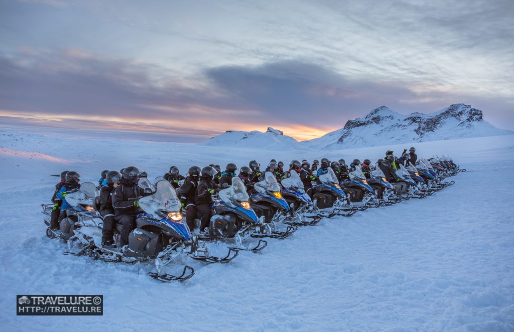 A long row of snowmobiles all set to take off in Langjökull