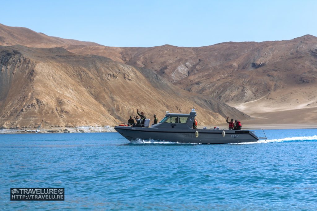 An army boat cutting across the lake