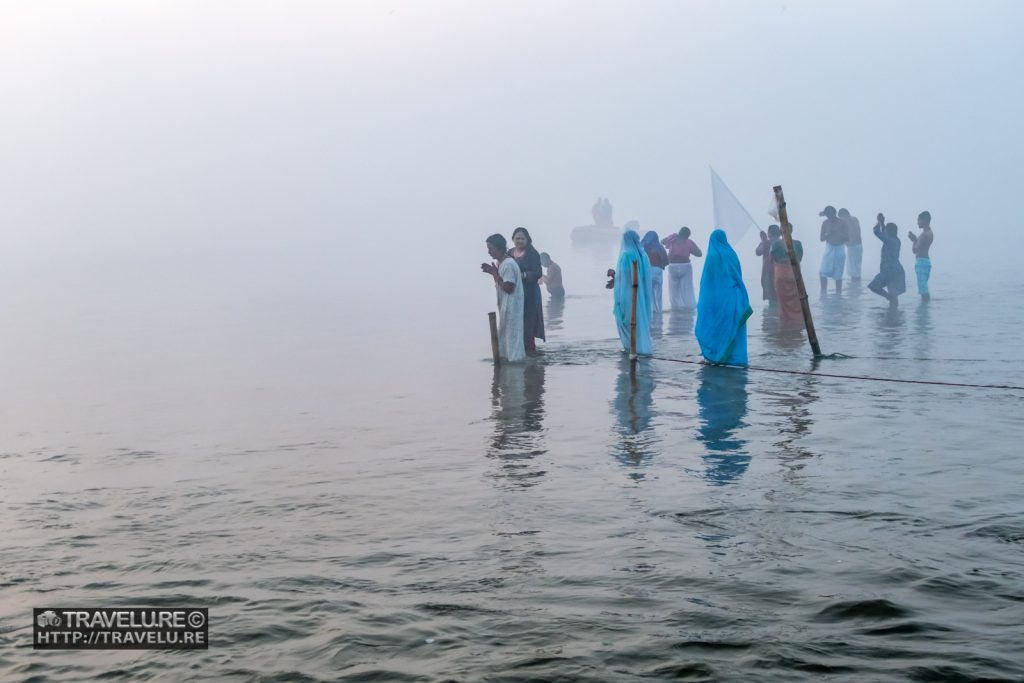 Morning mist creates a surreal setting for the holy dip at Kumbh