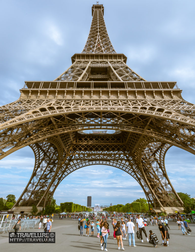 A wide angle shot of the Eiffel Tower from near its base - Travelure ©