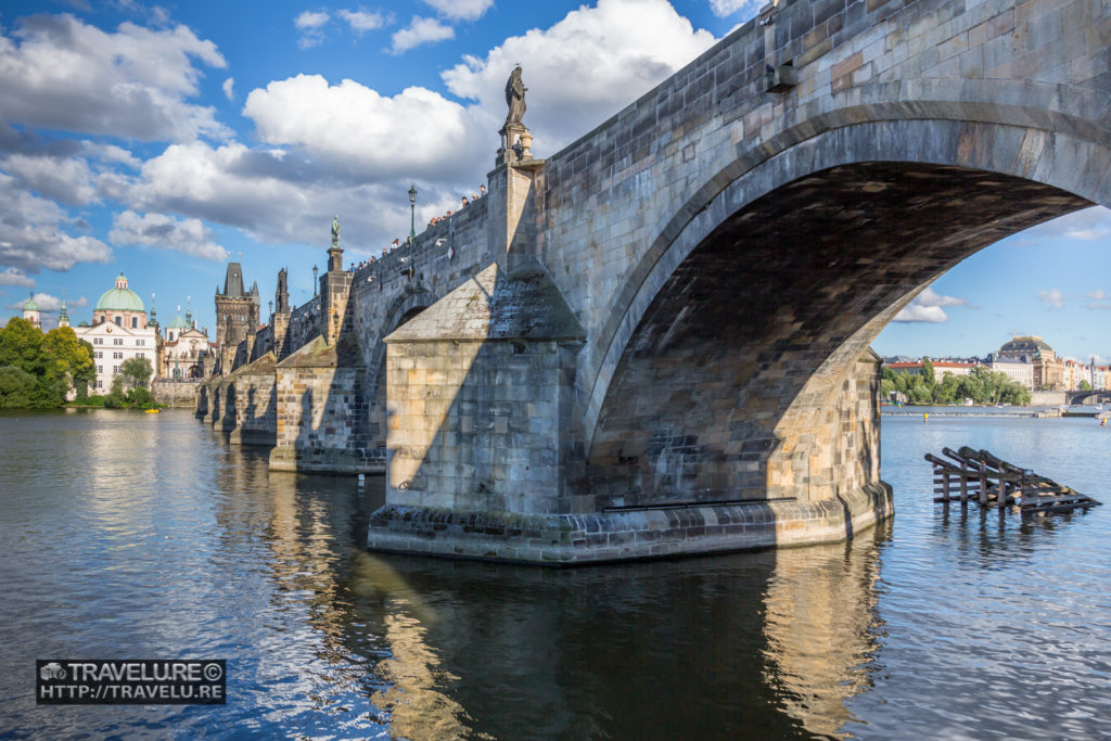 Charles Bridge with its Baroque statues. River Vltava from beneath. - Travelure ©