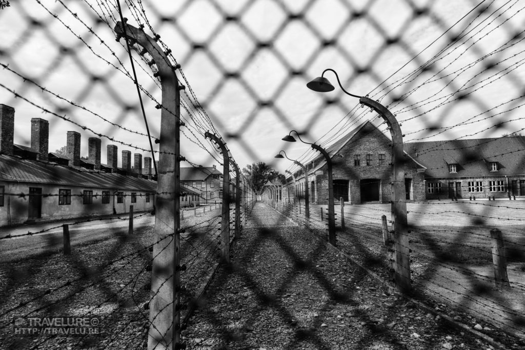 Electrified double fence to curb the interns from escaping. Guards patrolled the path between the fences with German Shepherd dogs. - Travelure ©