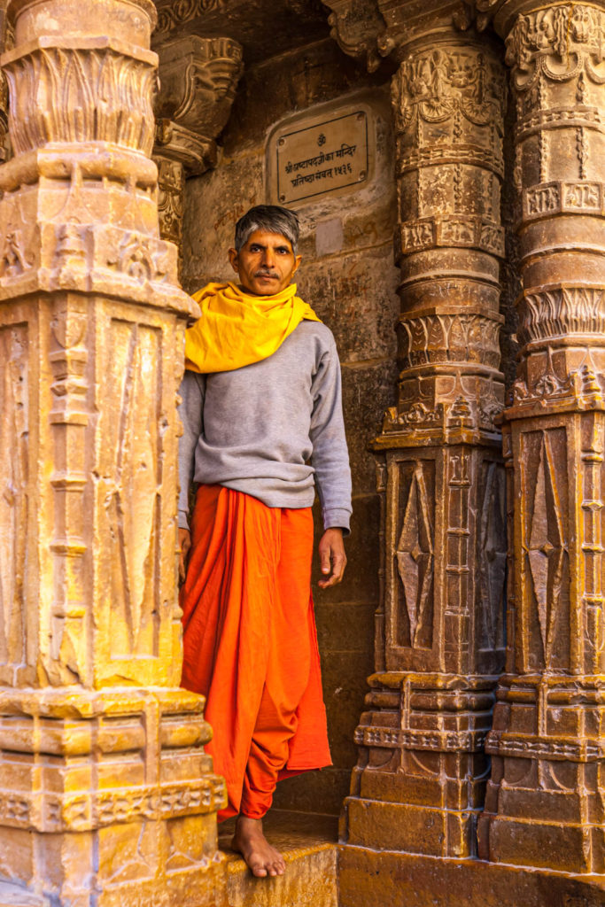 A priest looks out of the Jain Temple in Jaisalmer Fort - Travelure ©