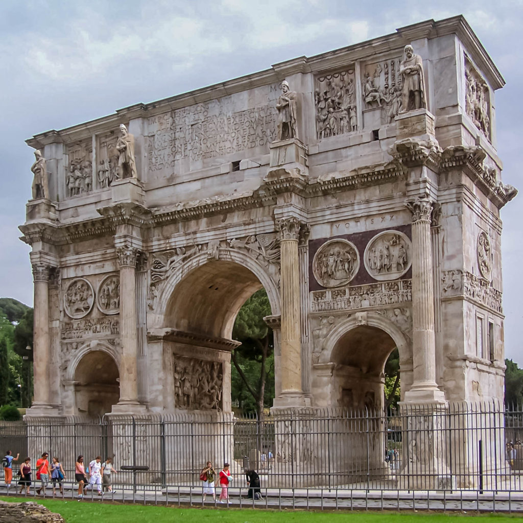 The stunning entrance arch of Colosseum - Travelure ©