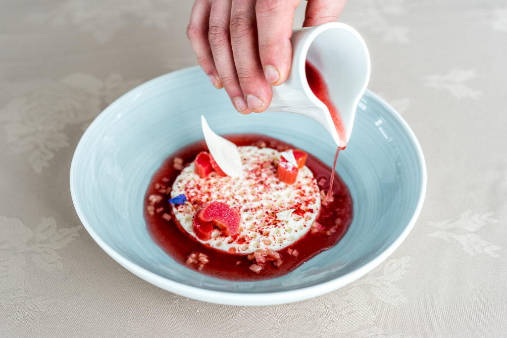 Plating up a dessert of pannacotta made of goat milk and rhubarb. Nuuk, Greenland. Shot by LolaHelsinki - Photo by Lola - Travelure ©