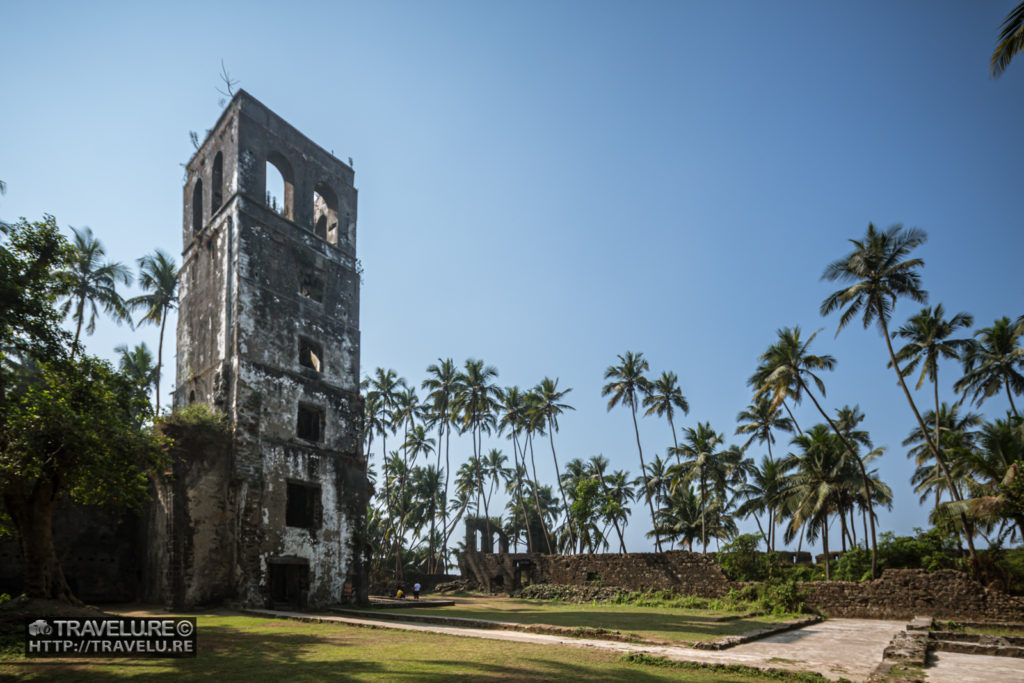 A roofless bell tower of a church in ruins bears a mute testimony to an era that was - Travelure ©